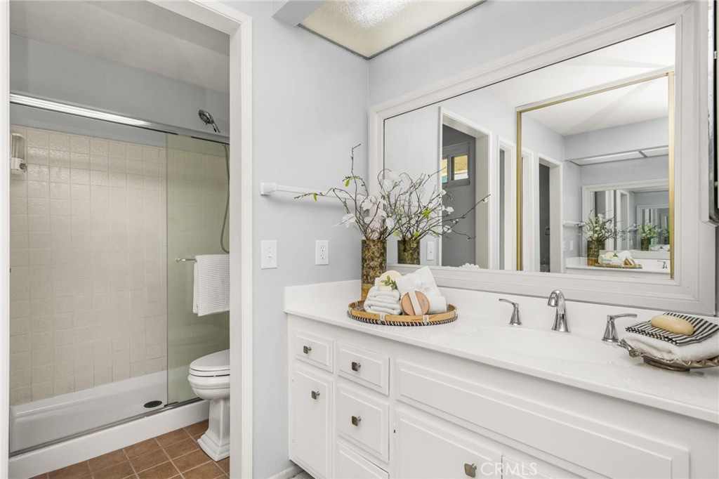 – Primary bath Bright primary bath featuring a spacious vanity, generous storage, and a glass-enclosed walk-in shower. - 6931 Danvers Dr, Garden Grove CA 92845 - photo 37
