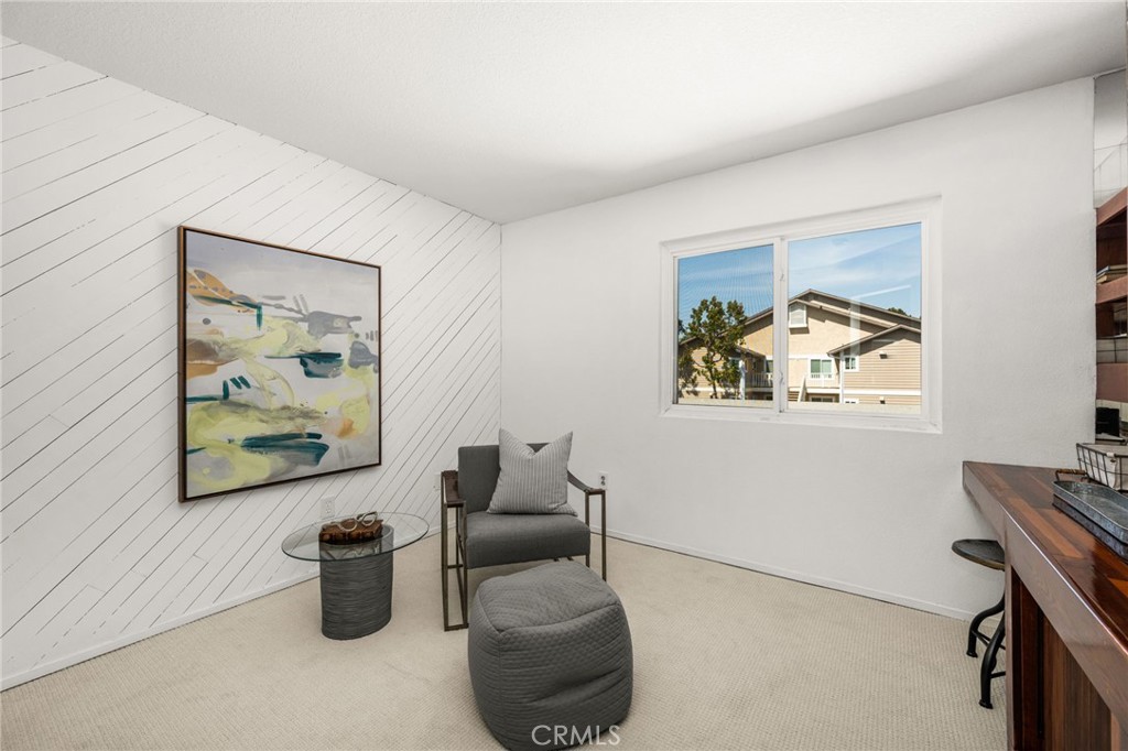 Third bedroom / office Inviting office space featuring a built-in wood desk, extensive shelving, and a bright window ove - 6931 Danvers Dr, Garden Grove CA 92845 - photo 42