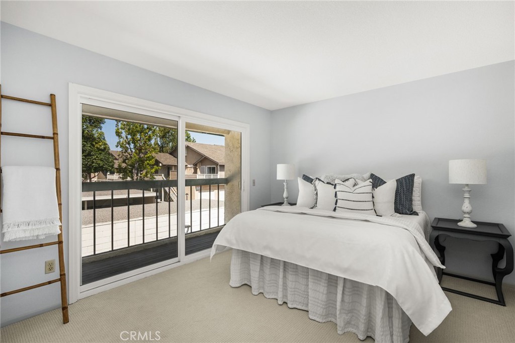 – Guest bedroom Bright guest bedroom with sliding glass doors opening to its own balcony—an inviting indoor-outdoor retr - 6931 Danvers Dr, Garden Grove CA 92845 - photo 47