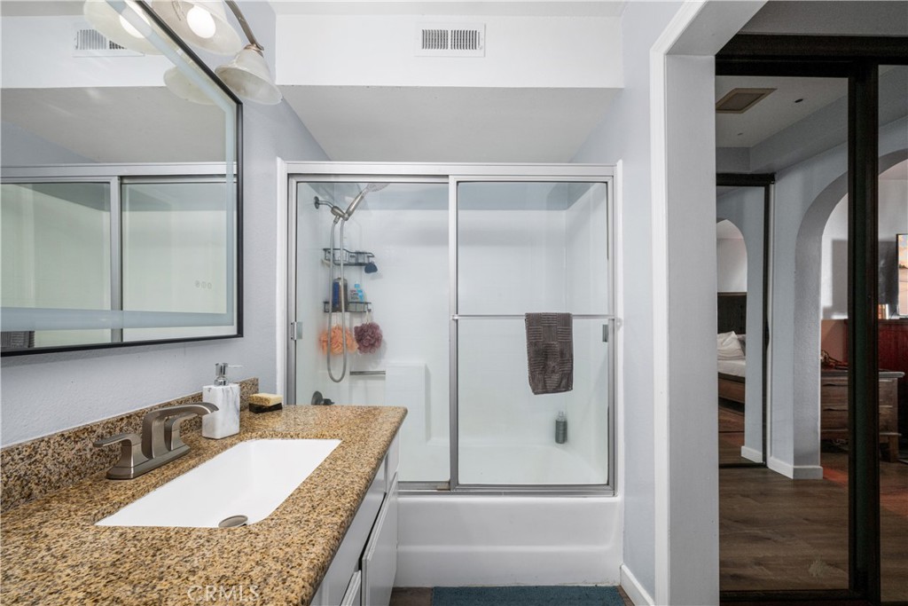 Second bath with custom mirrow, shower over tub, attached bedroom on right - 6971 Knollcrest #48 48, Garden Grove CA 92845 - photo 32