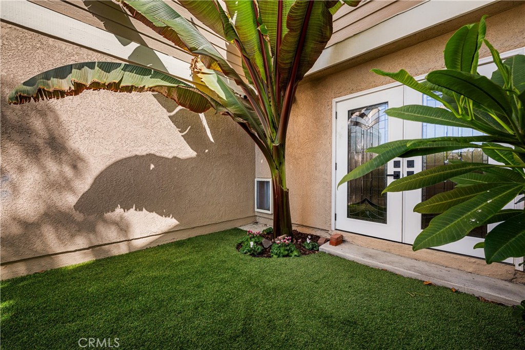back patio, view of stained glass doors, artifiial grass - 6971 Knollcrest #48 48, Garden Grove CA 92845 - photo 59