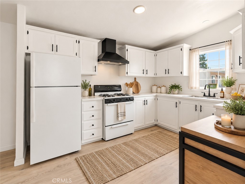 White kitchen with natural accents - 7887 Lampson Ave Avenue 10, Garden Grove CA 92841 - photo 5