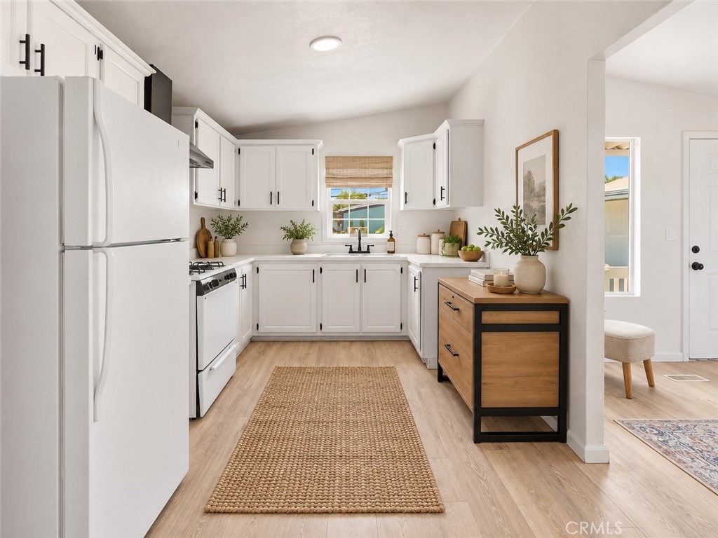 Clean kitchen with woven rug and decorative storage - 7887 Lampson Ave Avenue 10, Garden Grove CA 92841 - photo 9