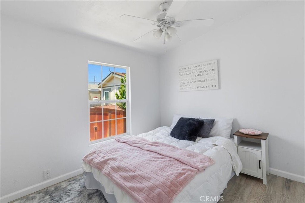 Bedroom with window and ceiling fan - 7887 Lampson Ave Avenue 10, Garden Grove CA 92841 - photo 13