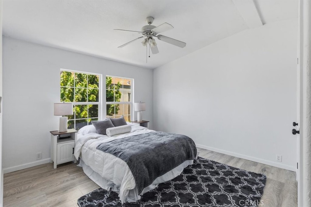 Spacious bedroom with ceiling fan. - 7887 Lampson Ave Avenue 10, Garden Grove CA 92841 - photo 21