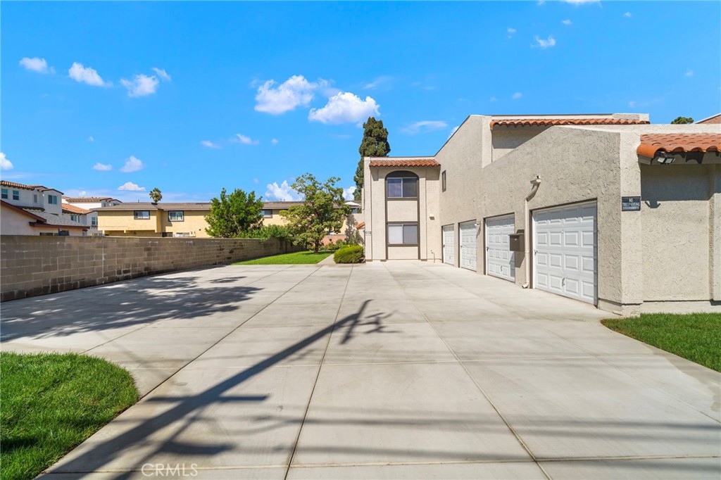The new driveway provides convenient access to the garages and additional parking beside the two-story building. - 9941 11th Street, Garden Grove CA 92844 - photo 2