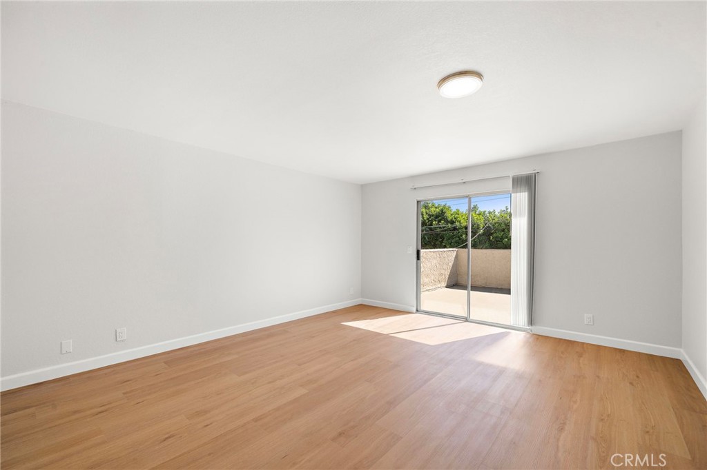 A sliding glass door connects this spacious room directly to the private balcony. - 9941 11th Street, Garden Grove CA 92844 - photo 23