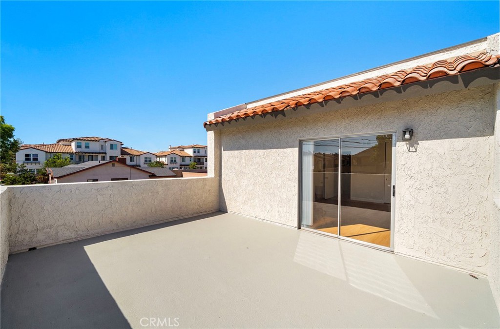The broad balcony extends the living space outdoors with convenient access through a sliding glass door. - 9941 11th Street, Garden Grove CA 92844 - photo 30