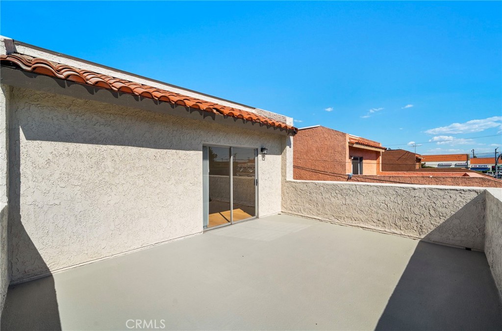 This additional balcony view highlights the generous outdoor floor area and sheltered building frontage. - 9941 11th Street, Garden Grove CA 92844 - photo 31