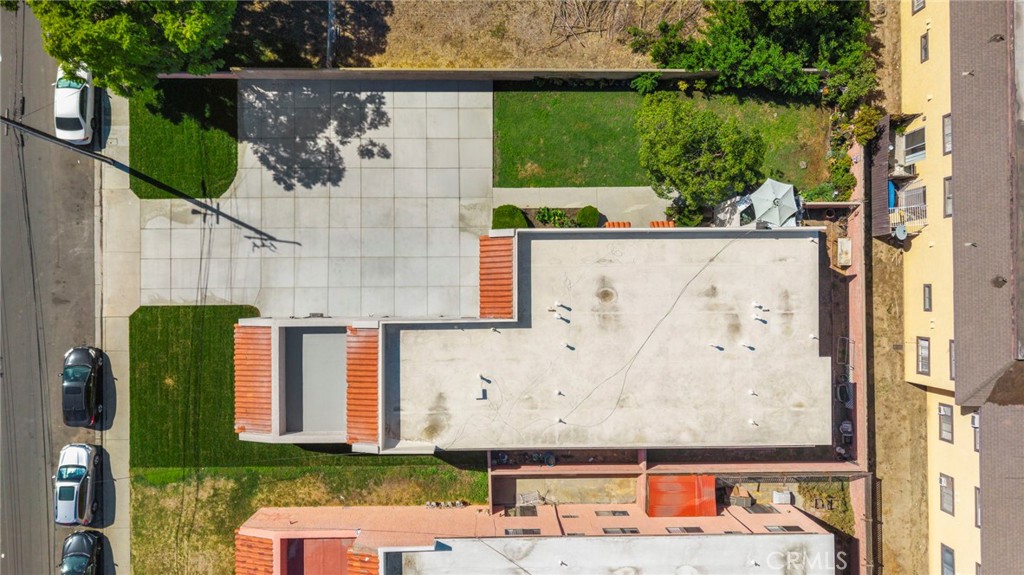 An overhead view shows the fourplex’s footprint, paved driveway, and landscaped areas across the 9,583-square-foot lot. - 9941 11th Street, Garden Grove CA 92844 - photo 32