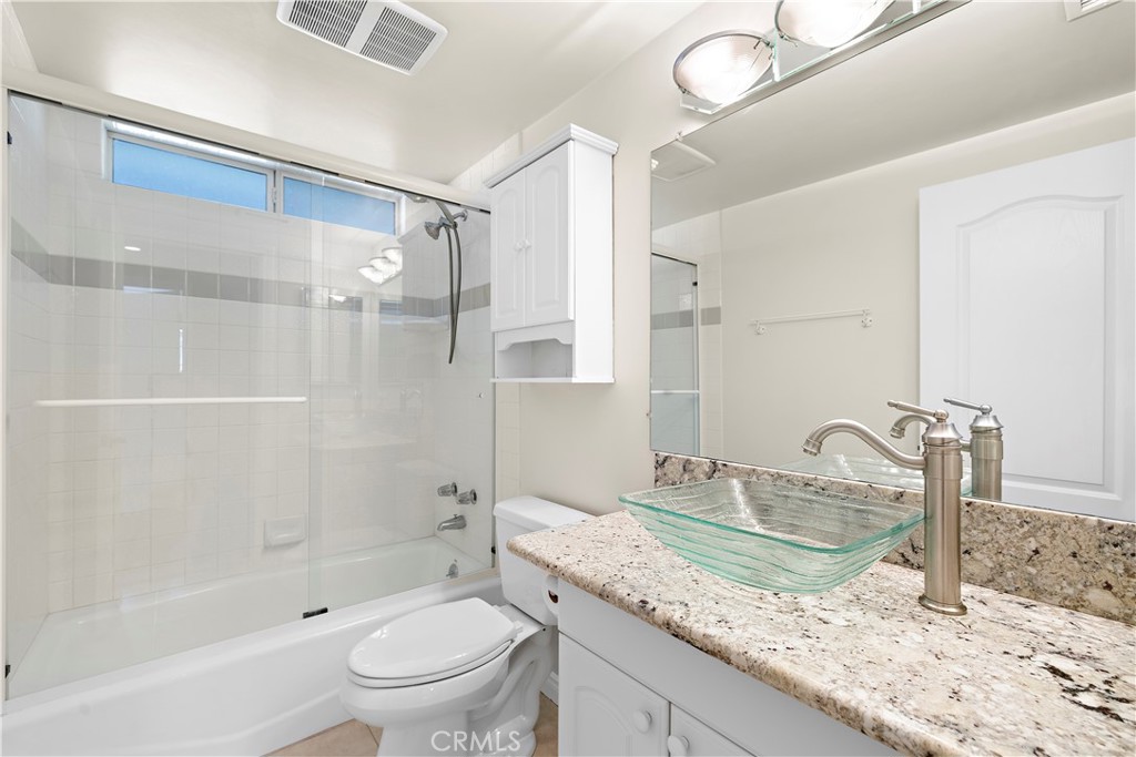 Secondary bathroom with shower/tub, granite counters and glass sink. - 10212 Valley Forge, Huntington Beach CA 92646 - photo 10