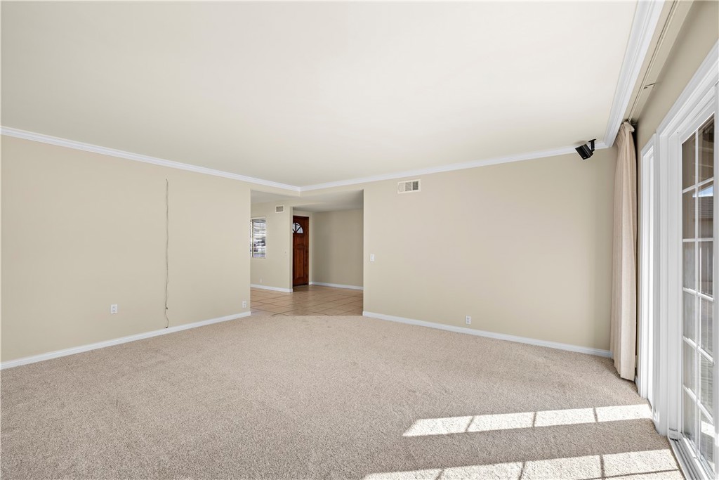 Living room toward front door unstaged. - 10212 Valley Forge, Huntington Beach CA 92646 - photo 31