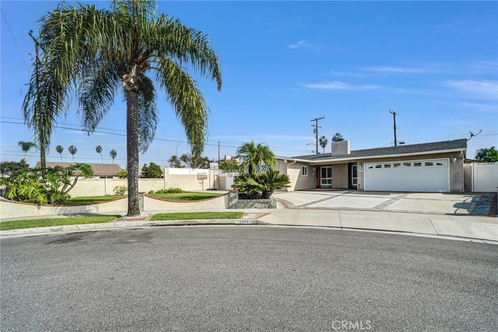 View of house and front yard to the left behind palm tree from Cul de Sac - 16502 Loire, Huntington Beach CA 92647 - photo 1