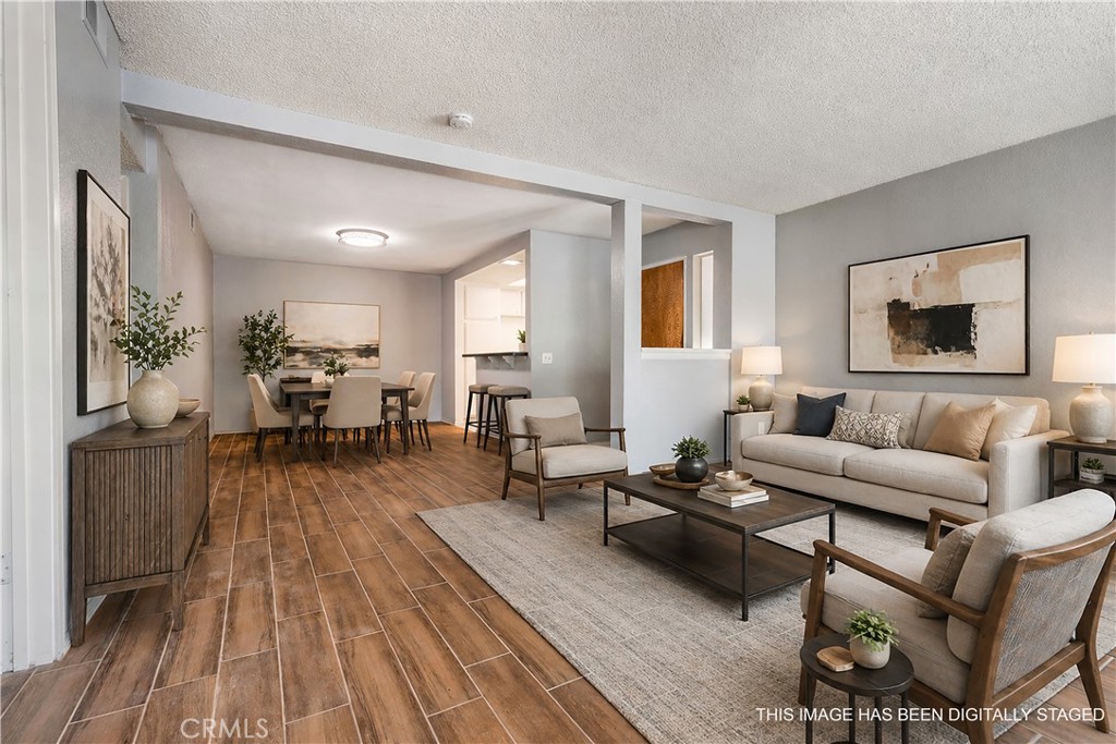 Virtually staged living room - 16581 Grunion 107, Huntington Beach CA 92649 - photo 1