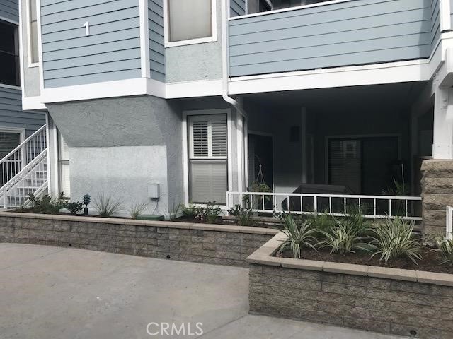 View approaching entry showing patio from outside - 16960 Algonquin, Huntington Beach CA 92649 - photo 2