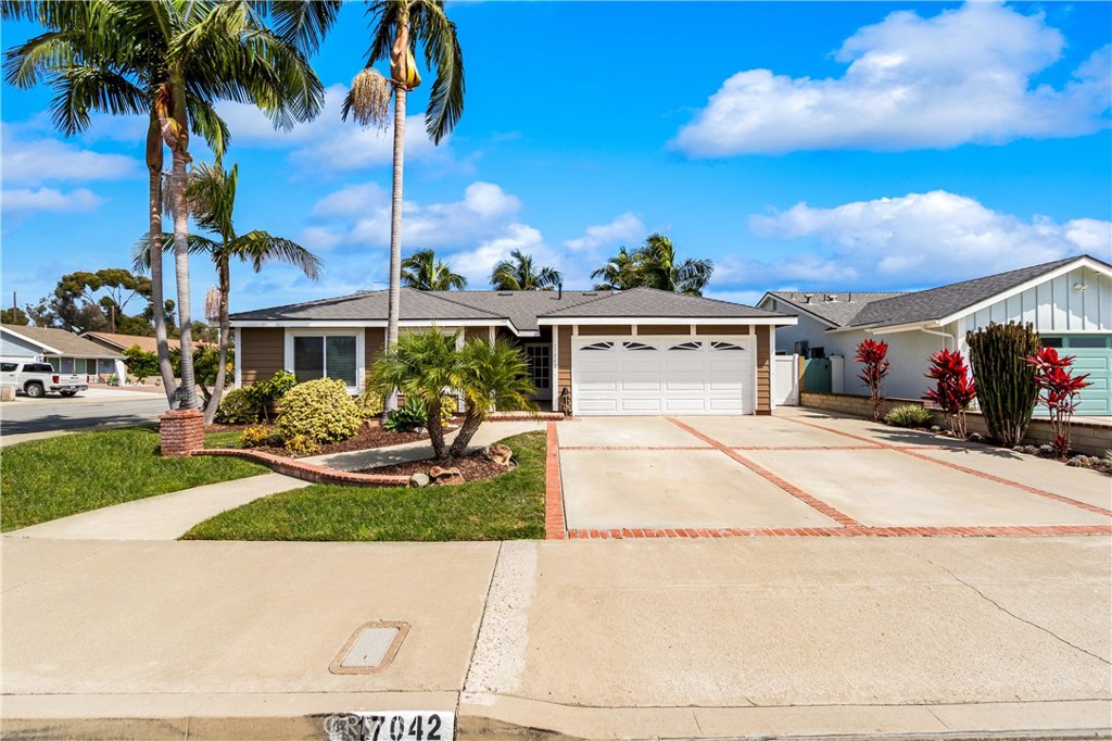 Spacious driveway with ample parking and a well-maintained front exterior. - 17042 Friml Lane, Huntington Beach CA 92649 - photo 2