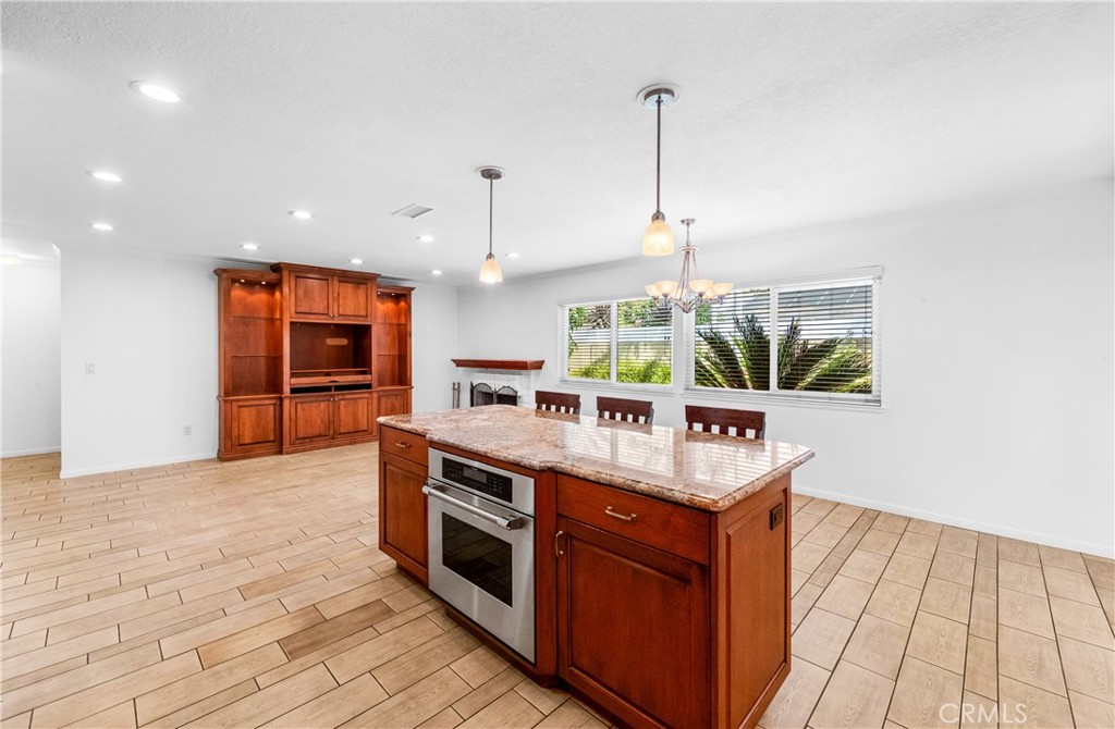 Kitchen with center island, abundant cabinetry, and convenient open-concept layout. - 17042 Friml Lane, Huntington Beach CA 92649 - photo 8