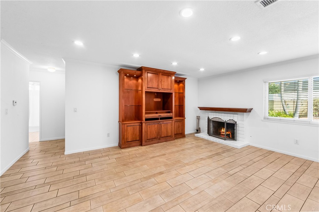 Bright kitchen and dining area with ample cabinet storage and recessed lighting. - 17042 Friml Lane, Huntington Beach CA 92649 - photo 9