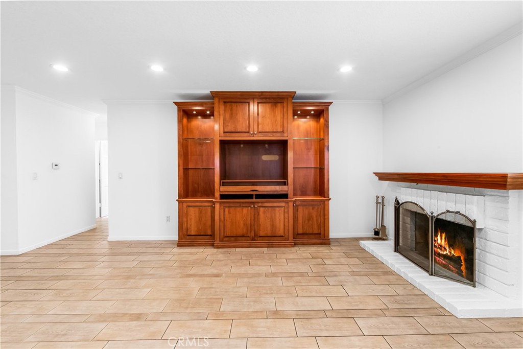 Kitchen features extensive cabinetry, center island, and open connection to the living space. - 17042 Friml Lane, Huntington Beach CA 92649 - photo 10