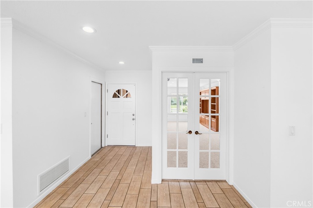 Bright interior hallway with beautifulwood-look flooring and convenient access to adjoining rooms. - 17042 Friml Lane, Huntington Beach CA 92649 - photo 17