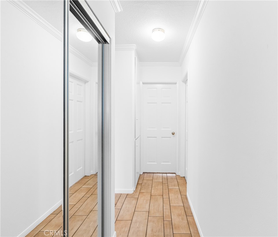 Interior hallway with ample storage and access to additional living spaces. - 17042 Friml Lane, Huntington Beach CA 92649 - photo 21