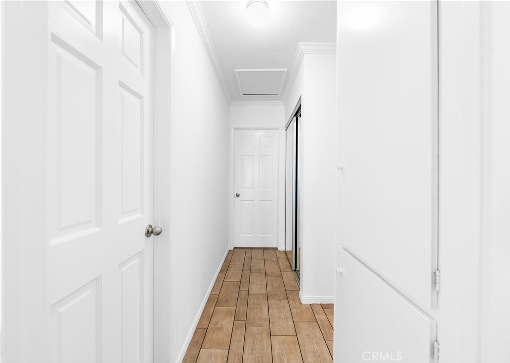 Bright hallway featuring clean finishes and convenient room access. - 17042 Friml Lane, Huntington Beach CA 92649 - photo 22