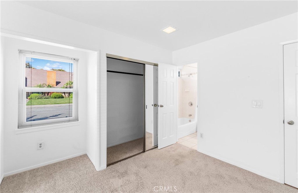 Bedroom 2 offers bright interior space with natural light and a clean, neutral finish. - 17042 Friml Lane, Huntington Beach CA 92649 - photo 26