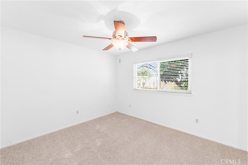 Primary bedroom is spacious with ceiling fan and generous natural light. - 17042 Friml Lane, Huntington Beach CA 92649 - photo 30