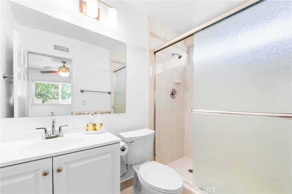 Primary bathroom with vanity, storage, and walk-in shower. - 17042 Friml Lane, Huntington Beach CA 92649 - photo 33