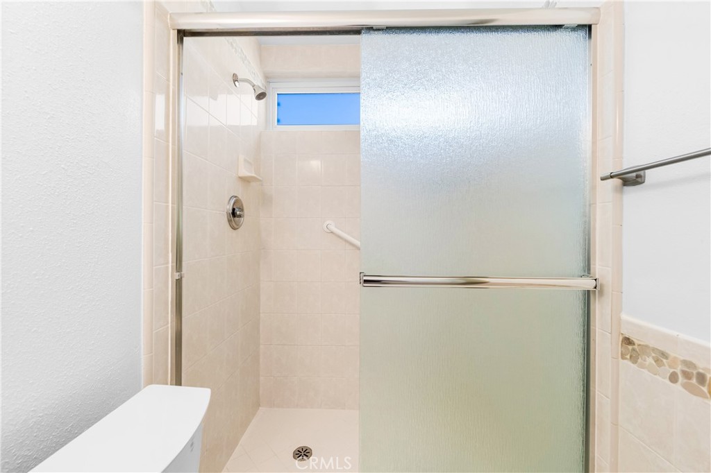 Clean shower area with neutral finishes. - 17042 Friml Lane, Huntington Beach CA 92649 - photo 34
