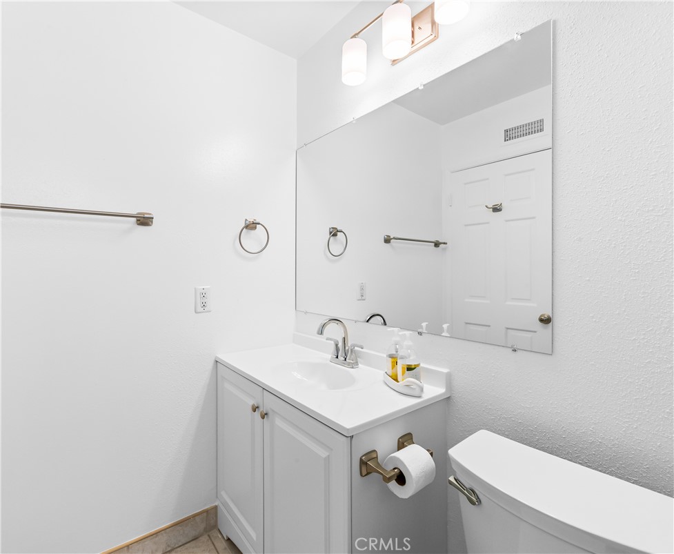 Well-maintained bathroom area with vanity, storage, new paint all throughout. - 17042 Friml Lane, Huntington Beach CA 92649 - photo 35