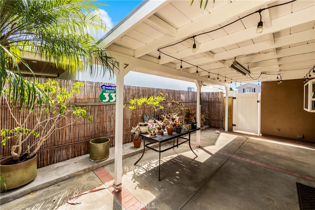 Covered patio overlooks the landscaped backyard. - 17042 Friml Lane, Huntington Beach CA 92649 - photo 41