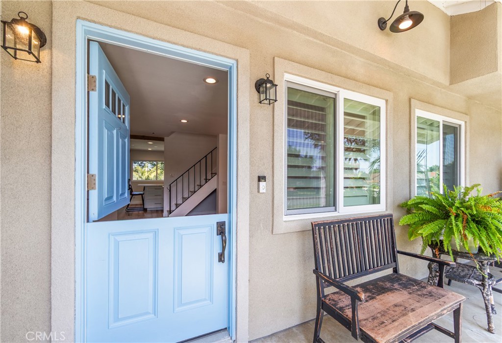 Welcoming entry with French-style doors, natural light and outdoor views. - 17327 Apel Lane, Huntington Beach CA 92649 - photo 2