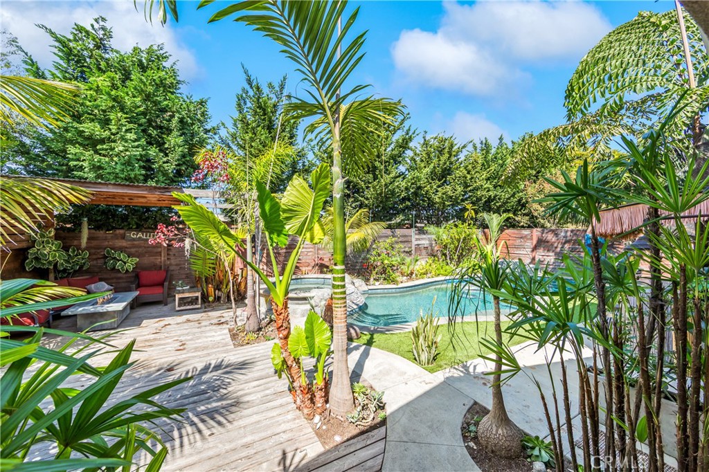 Tropical backyard oasis with sparkling pool and lush mature landscaping. - 17327 Apel Lane, Huntington Beach CA 92649 - photo 6