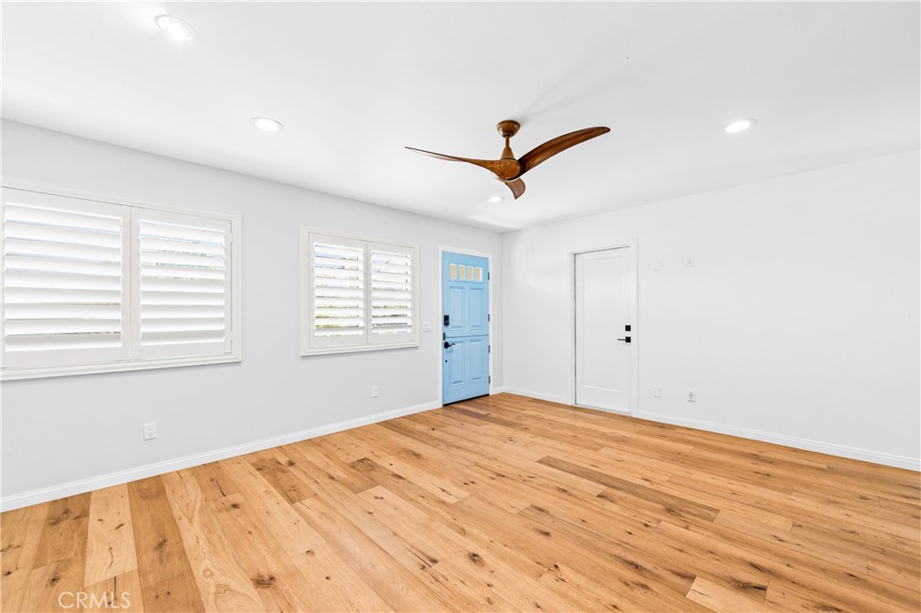 Open living space with oversized windows, wood flooring and a bright airy feel. - 17327 Apel Lane, Huntington Beach CA 92649 - photo 7