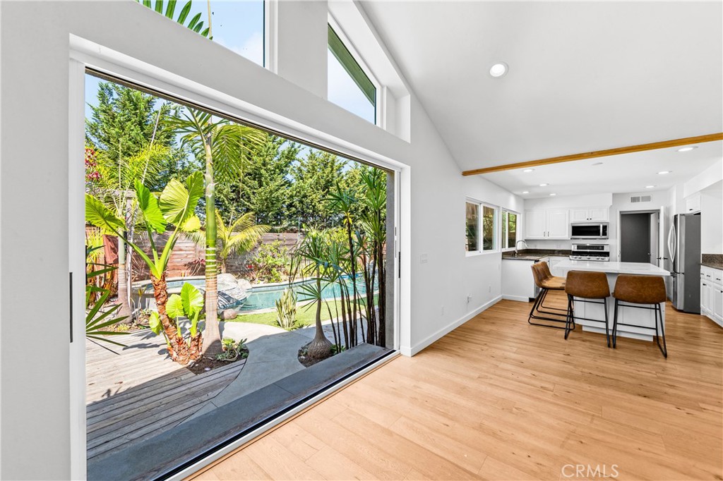 Seamless indoor-outdoor connection with expansive glass doors opening to the patio. - 17327 Apel Lane, Huntington Beach CA 92649 - photo 10