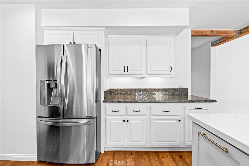 Bright kitchen featuring crisp cabinetry, stainless-steel appliances and ample workspace. - 17327 Apel Lane, Huntington Beach CA 92649 - photo 14