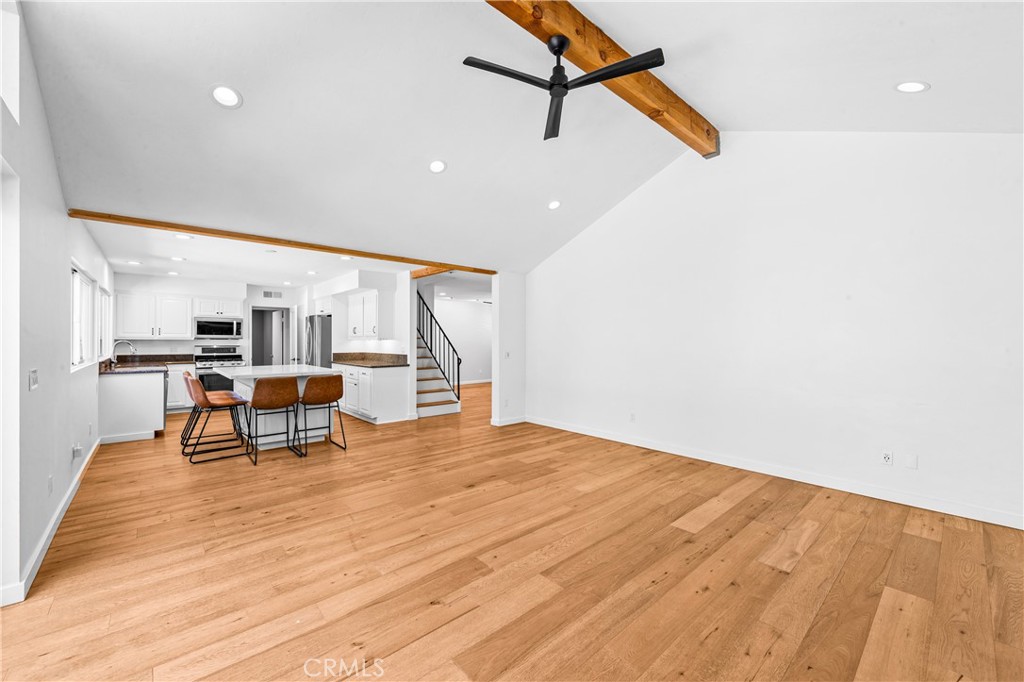 Spacious living area with wood flooring, ceiling fan and contemporary recessed lighting. - 17327 Apel Lane, Huntington Beach CA 92649 - photo 17