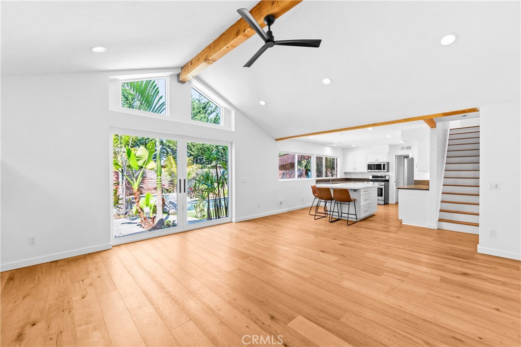 Light-filled living space with expansive windows overlooking the outdoor retreat. - 17327 Apel Lane, Huntington Beach CA 92649 - photo 18