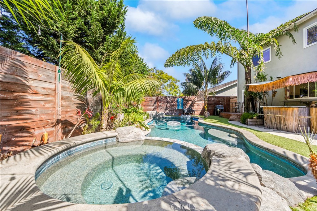 Beautifully landscaped pool area creates a private resort-like outdoor retreat. - 17327 Apel Lane, Huntington Beach CA 92649 - photo 23