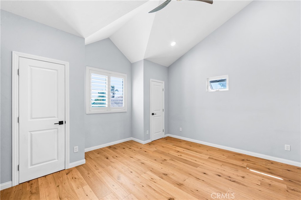 Bright bedroom with wood flooring, plantation shutters and polished contemporary finishes. - 17327 Apel Lane, Huntington Beach CA 92649 - photo 28