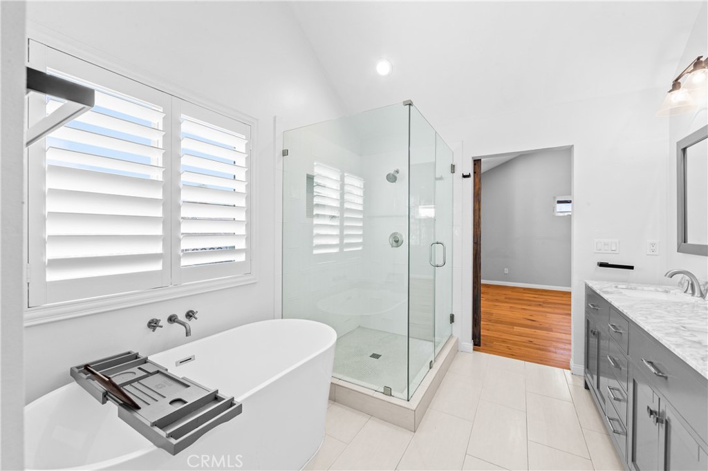 Spa-inspired bathroom with glass-enclosed shower and modern finishes. - 17327 Apel Lane, Huntington Beach CA 92649 - photo 33
