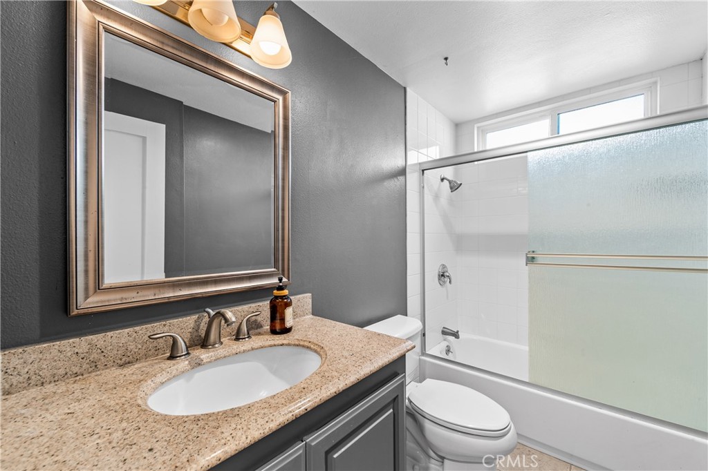Updated bathroom with contemporary vanity, modern fixtures and glass-enclosed shower. - 17327 Apel Lane, Huntington Beach CA 92649 - photo 39
