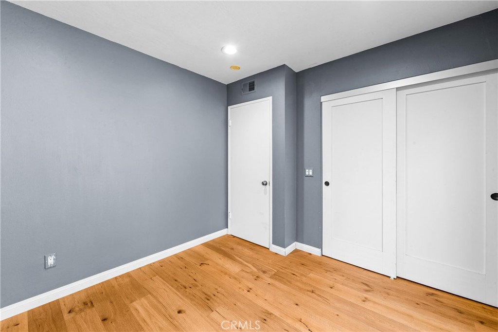 Comfortable bedroom retreat with wood flooring, natural light and generous closet space. - 17327 Apel Lane, Huntington Beach CA 92649 - photo 43