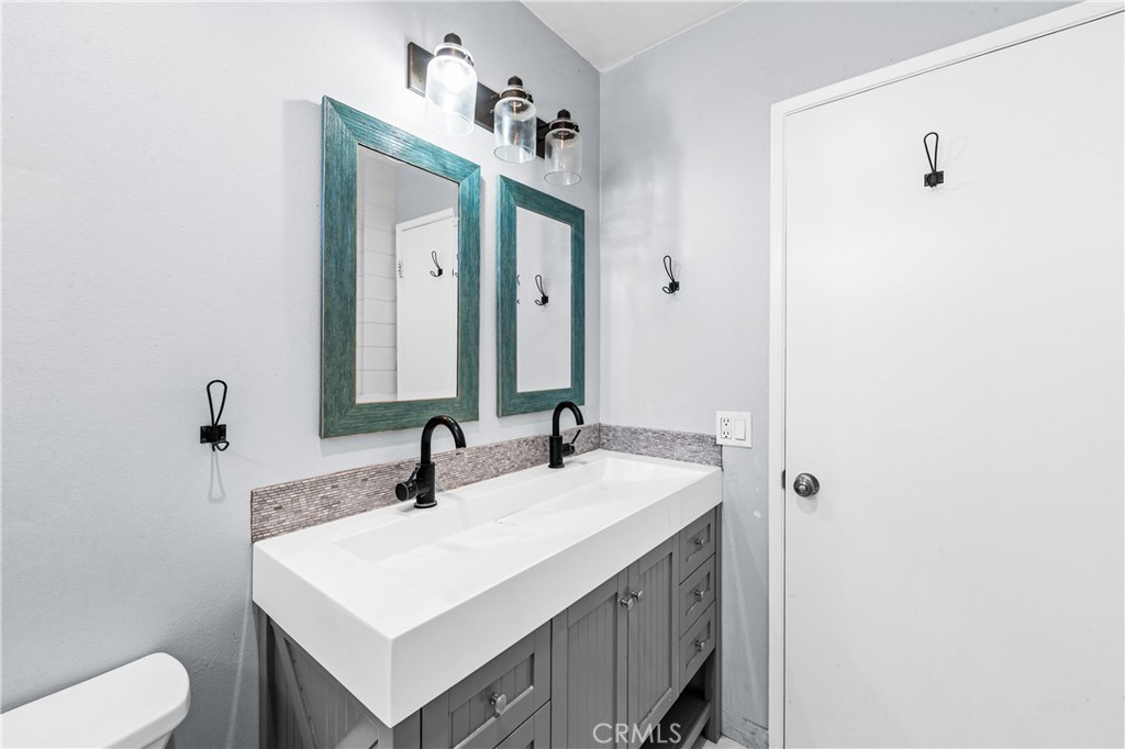 Freshly finished bathroom with dual vanity, contemporary fixtures and clean design. - 17327 Apel Lane, Huntington Beach CA 92649 - photo 45