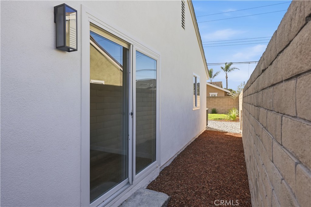 Side yard. Direct access to one of the bedrooms. - 17781 Flintstone Lane, Huntington Beach CA 92647 - photo 26