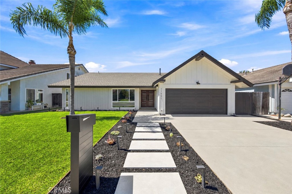 Large-format pavers, fresh sod, and new landscaping lead to the contemporary double-door entry. - 17951 Whitford Lane, Huntington Beach CA 92649 - photo 1