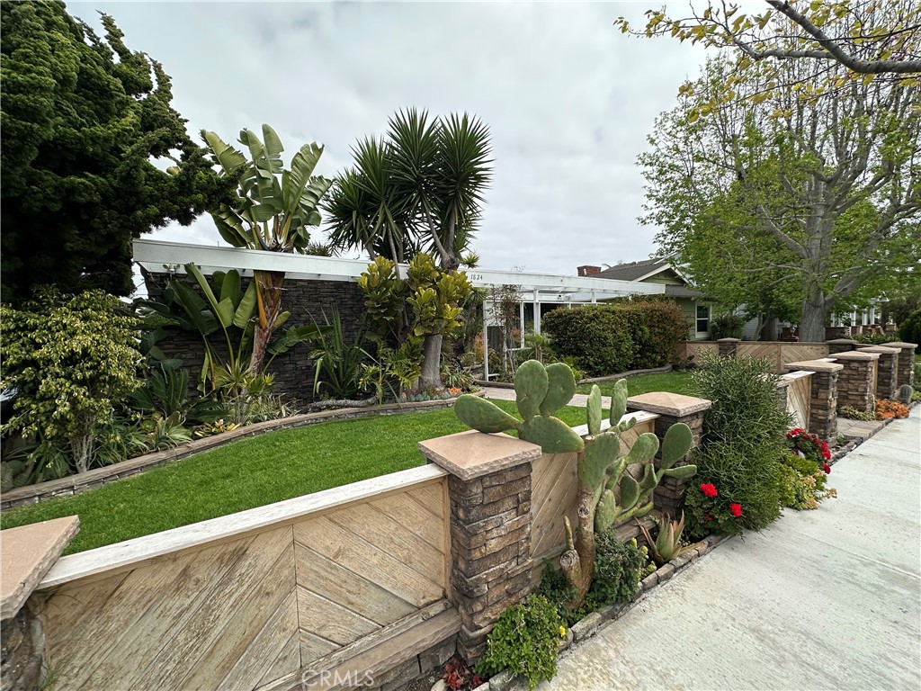 Inviting street presence highlighted by mature landscaping and a thoughtfully maintained front lawn. - 1824 Park Street, Huntington Beach CA 92648 - photo 1