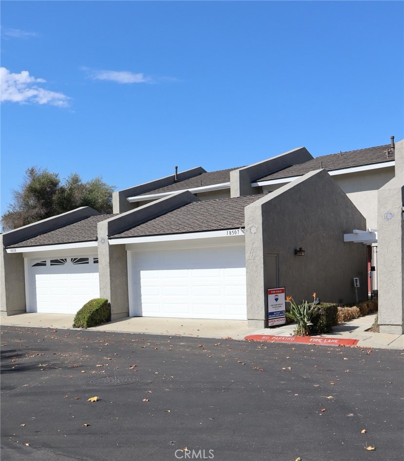 Front, 2 car garage (center), entry sidewalk - 18507 Pueblo Circle, Huntington Beach CA 92646 - photo 1