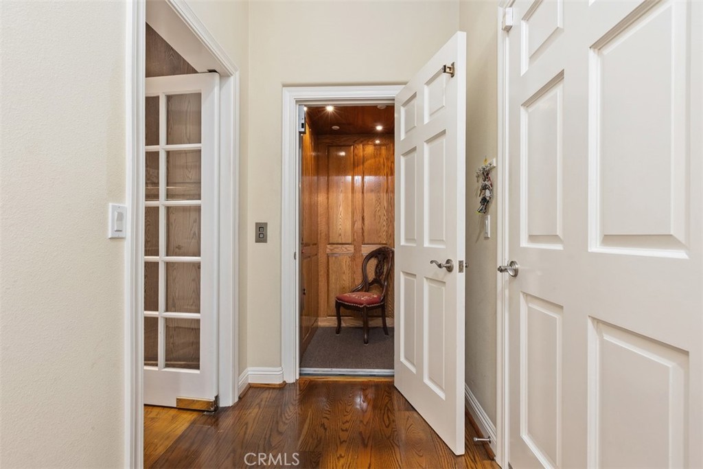 Private elevator at the end of the hall. - 18732 Jockey Circle, Huntington Beach CA 92648 - photo 9